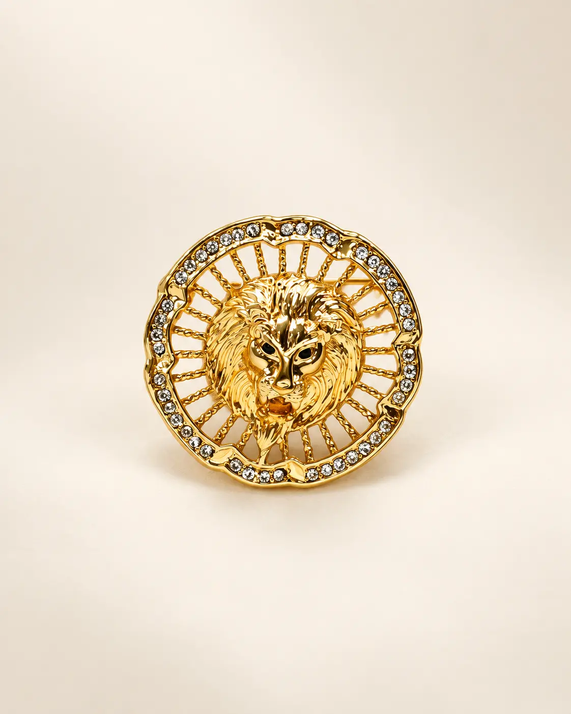 Gold-Tone Lion Medallion Brooch with Clear Stone Border